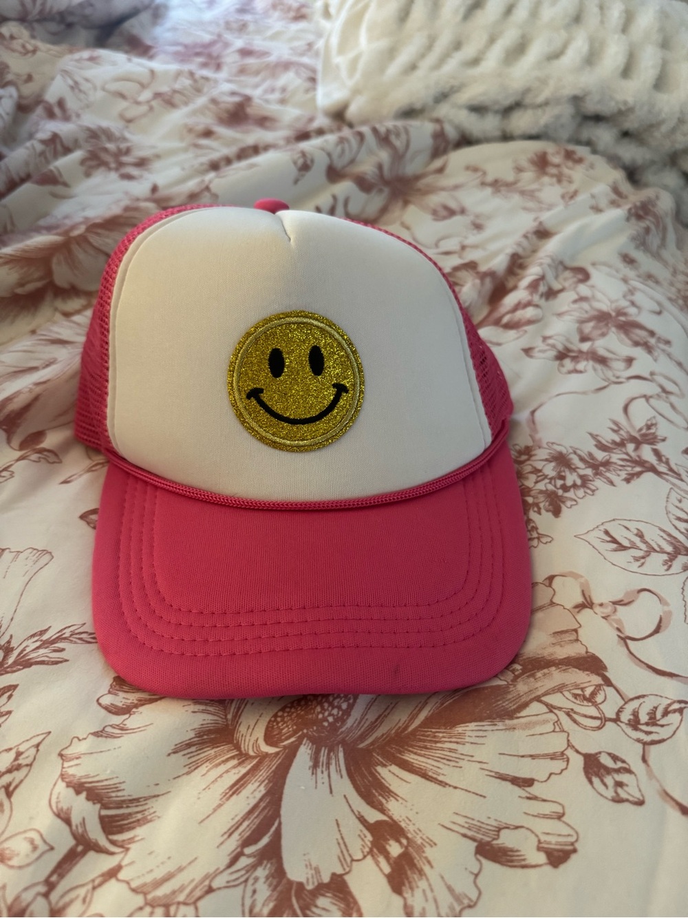Pink and White Trucker Hat with Gold Smiley Patch
